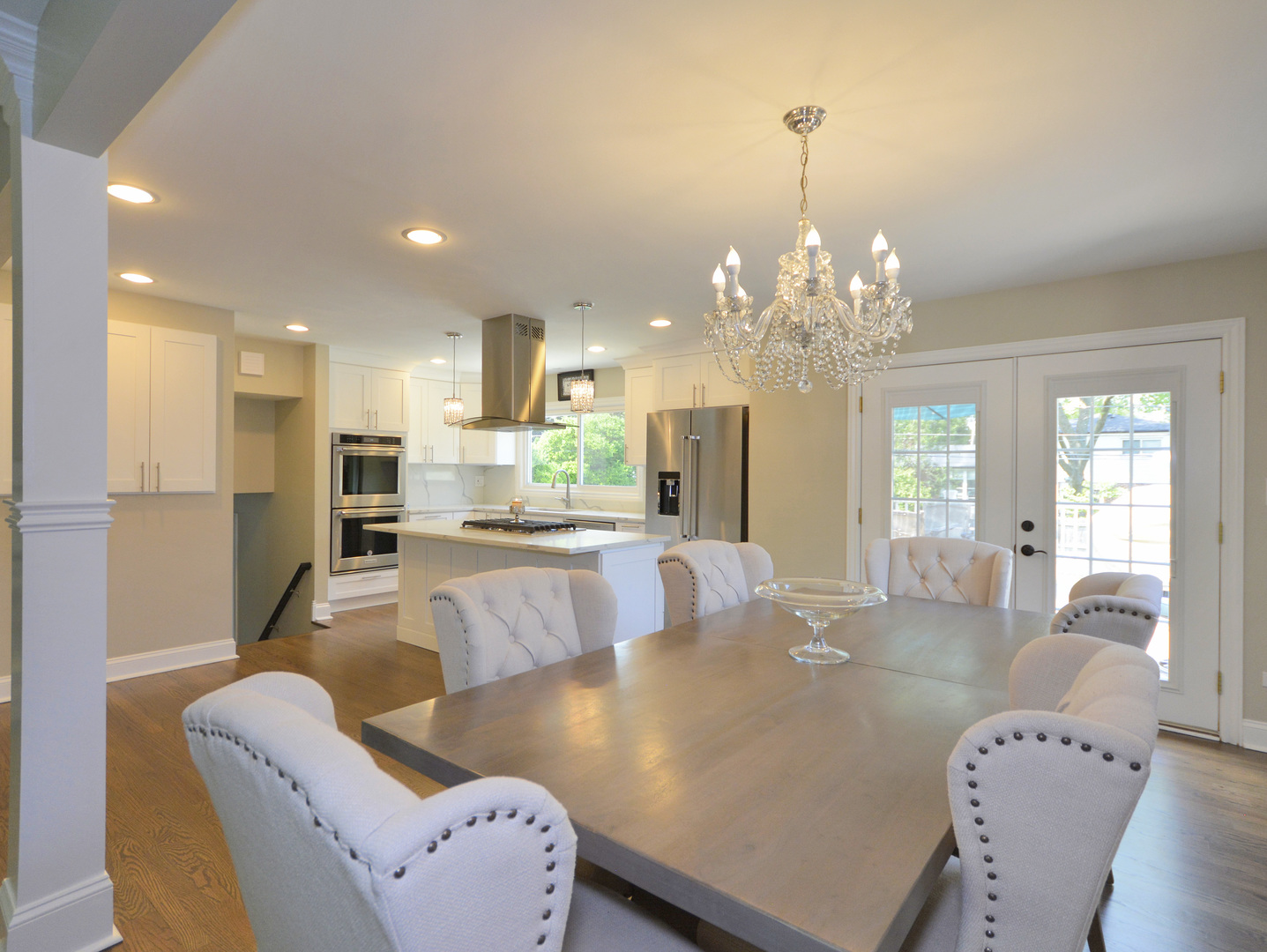 100 Ambleside Road Des Plaines, IL 60016 - Photo 4 of 15 a living room with kitchen island furniture and a chandelier