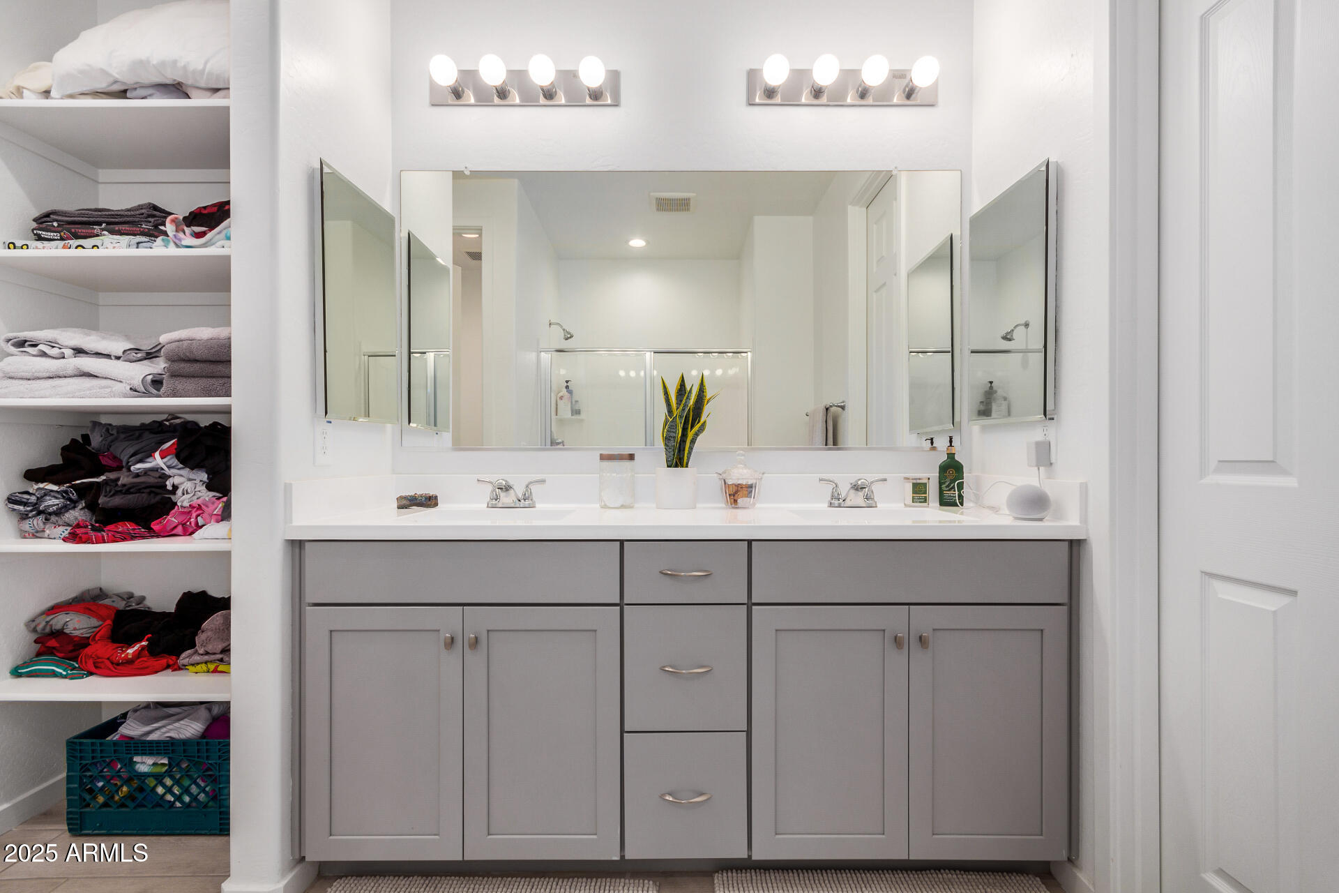 13319 West Red Range Way Peoria, AZ 85383 - Photo 19 of 38 a bathroom with a double vanity sink a and a mirror