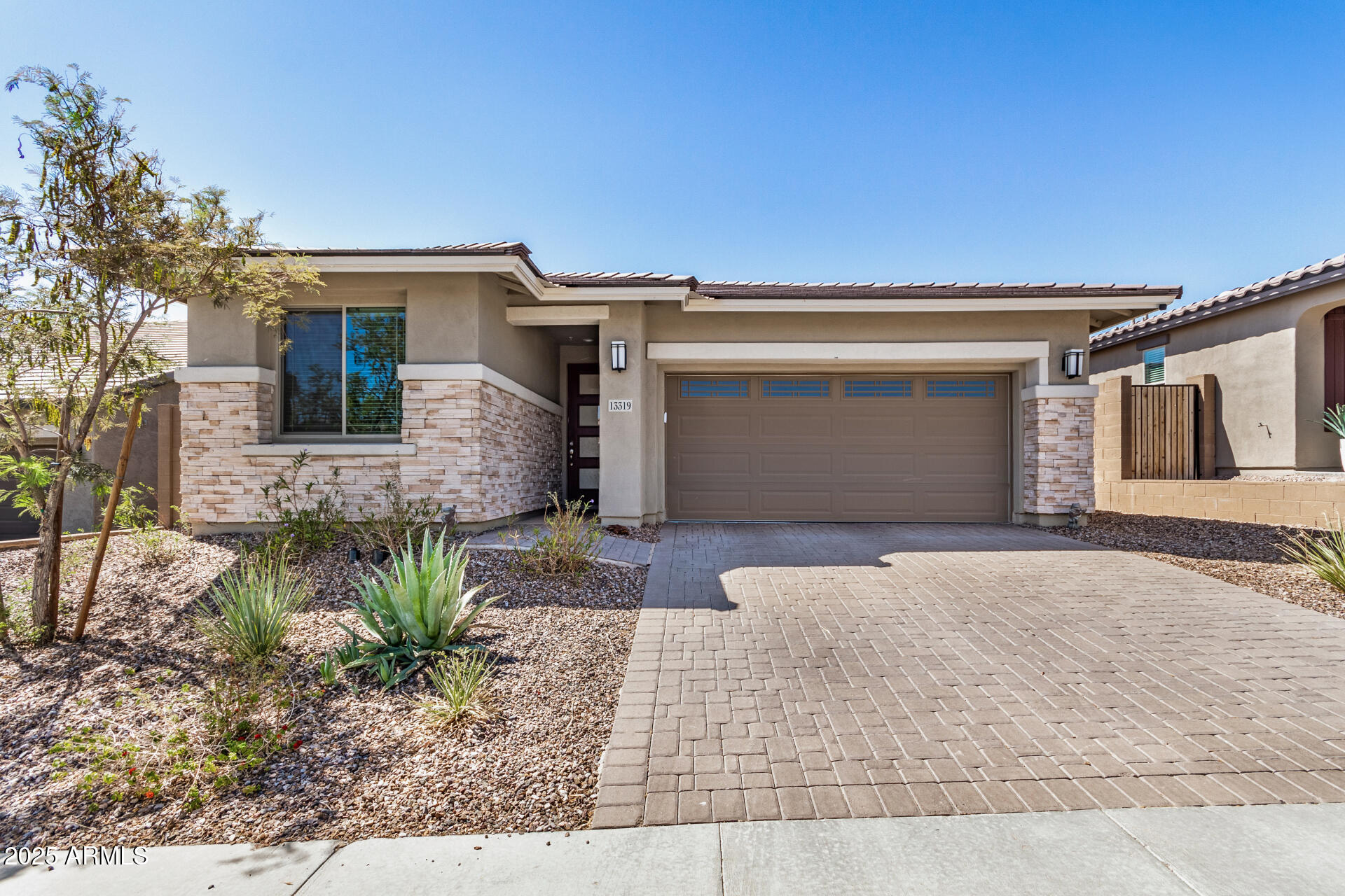 13319 West Red Range Way Peoria, AZ 85383 - Photo 2 of 38 a front view of a house with garden