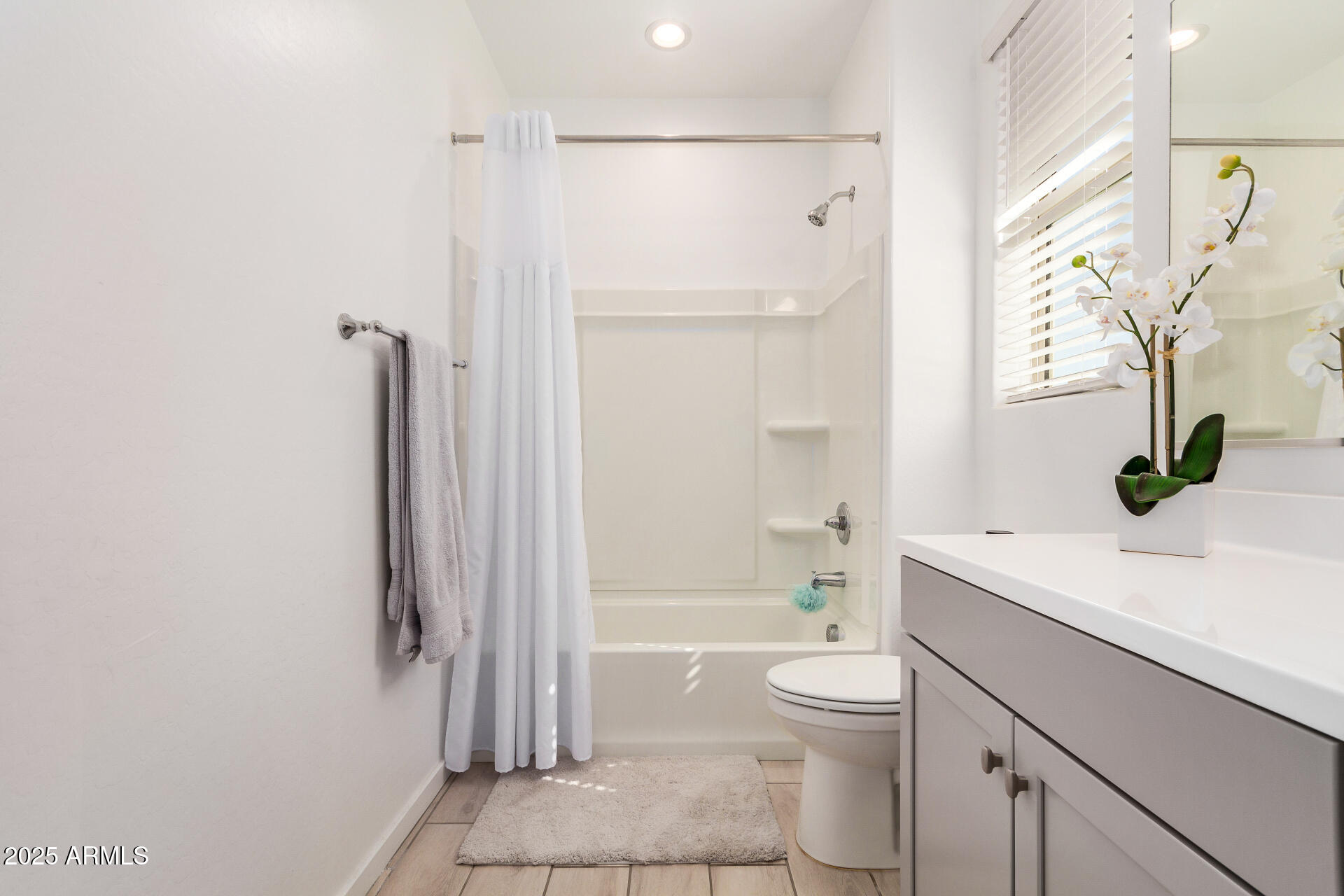 13319 West Red Range Way Peoria, AZ 85383 - Photo 31 of 38 a bathroom with a granite countertop sink toilet and shower