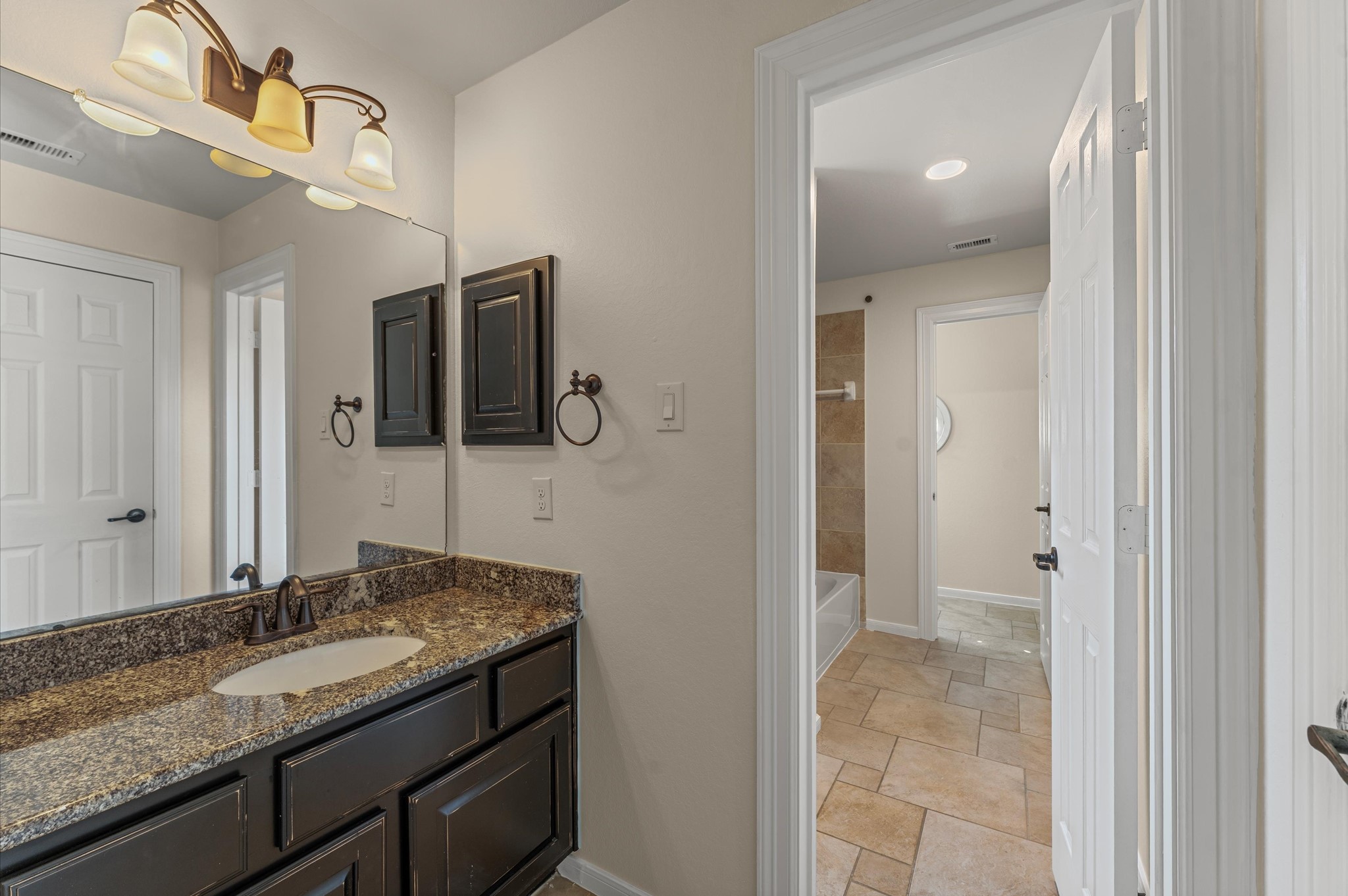 7 North Beech Springs Circle Spring, TX 77389 - Photo 36 of 50 a bathroom with a granite countertop sink and a mirror