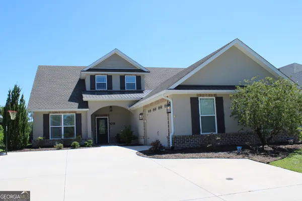 a front view of a house with yard
