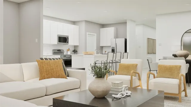 a living room with furniture flat screen tv and chairs