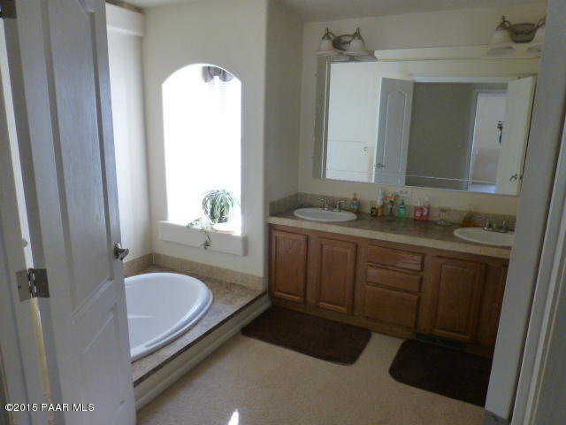 3893 Verde Road Ash Fork, AZ 86320 - Photo 26 of 33 a bathroom with a granite countertop sink and a mirror
