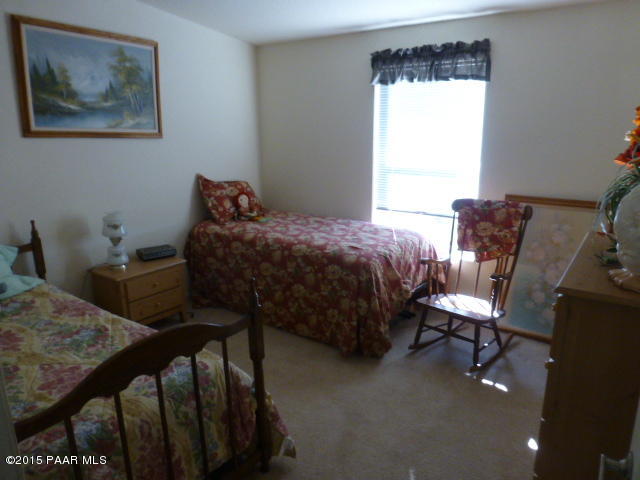 3893 Verde Road Ash Fork, AZ 86320 - Photo 33 of 33 a bedroom with a bed chair and window