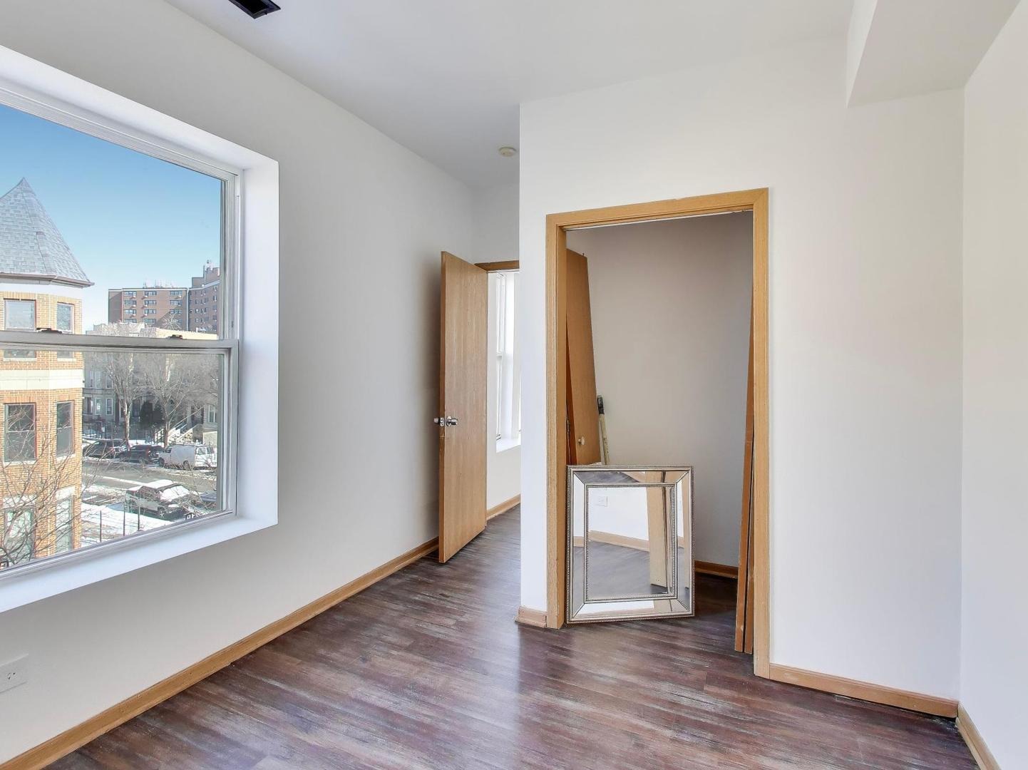 5000 South Champlain Avenue, Unit 3 Chicago, IL 60615 - Photo 12 of 17 a view of a hallway with wooden floor and a bathroom