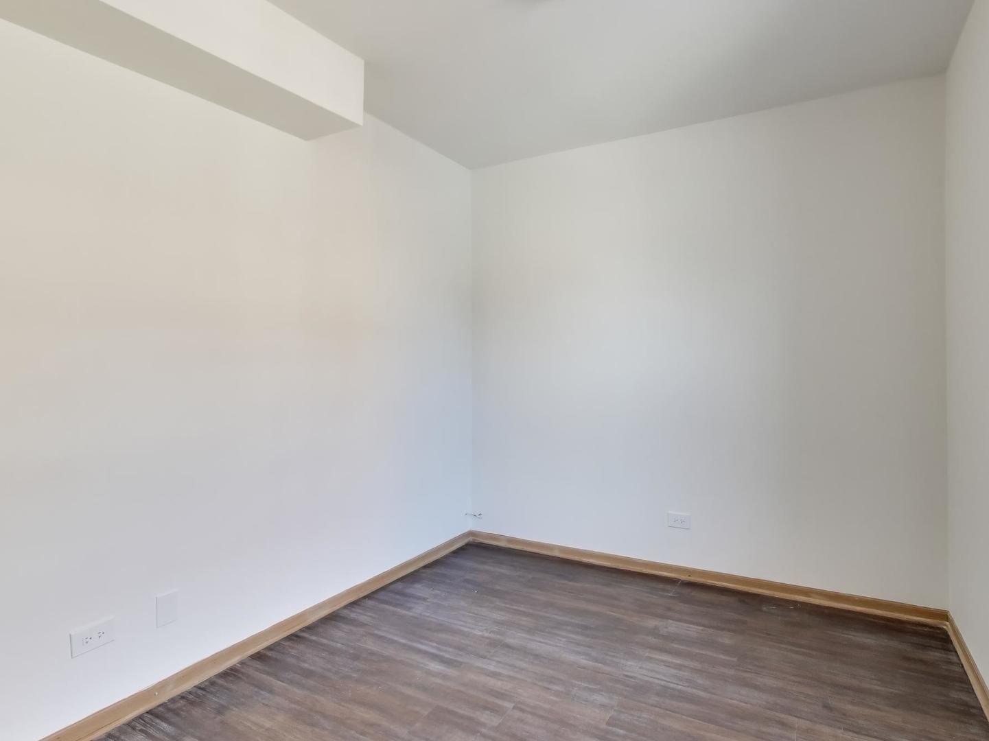 5000 South Champlain Avenue, Unit 3 Chicago, IL 60615 - Photo 14 of 17 a view of an empty room with wooden floor
