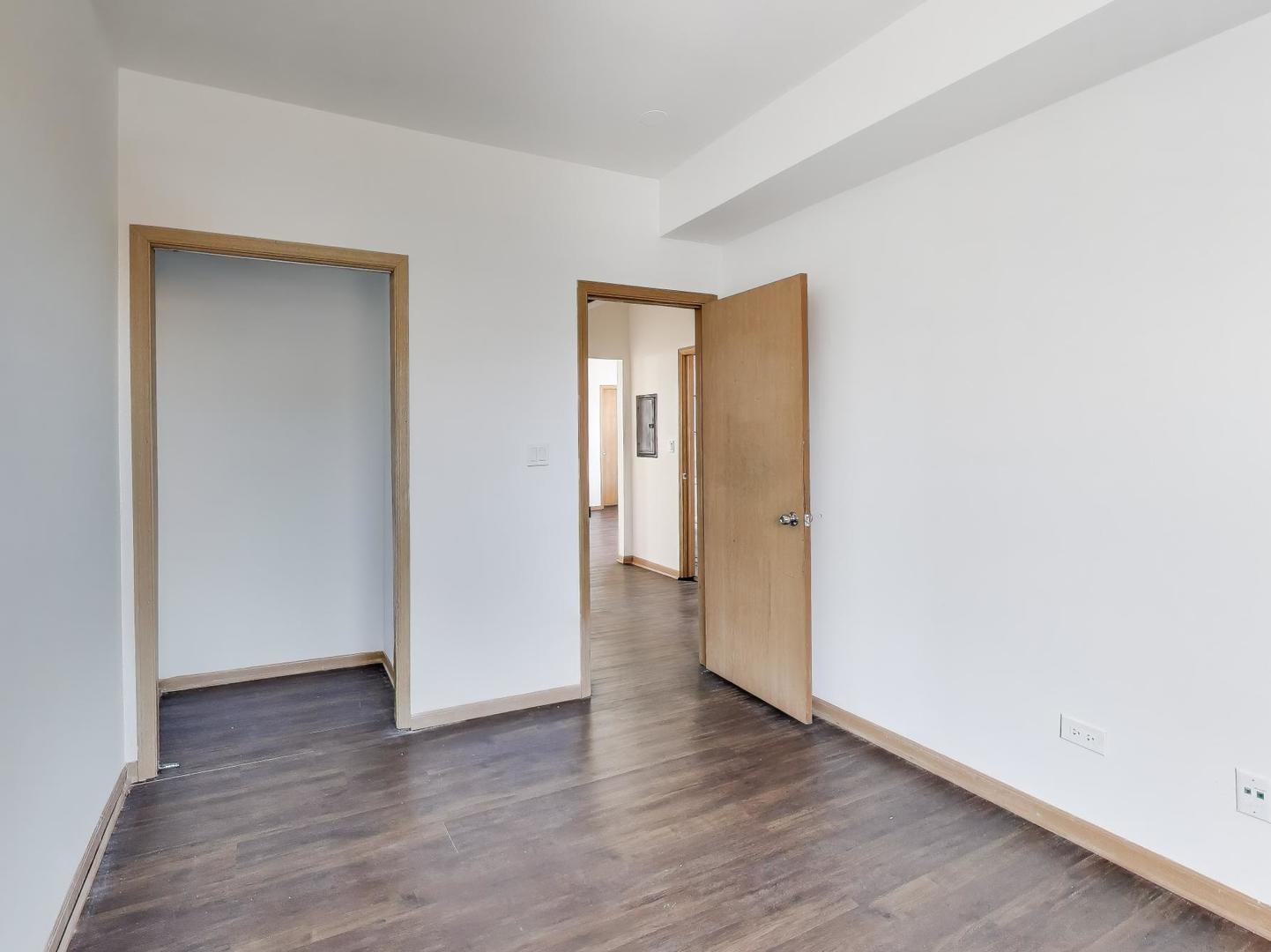 5000 South Champlain Avenue, Unit 3 Chicago, IL 60615 - Photo 15 of 17 an empty room with wooden floor and closet