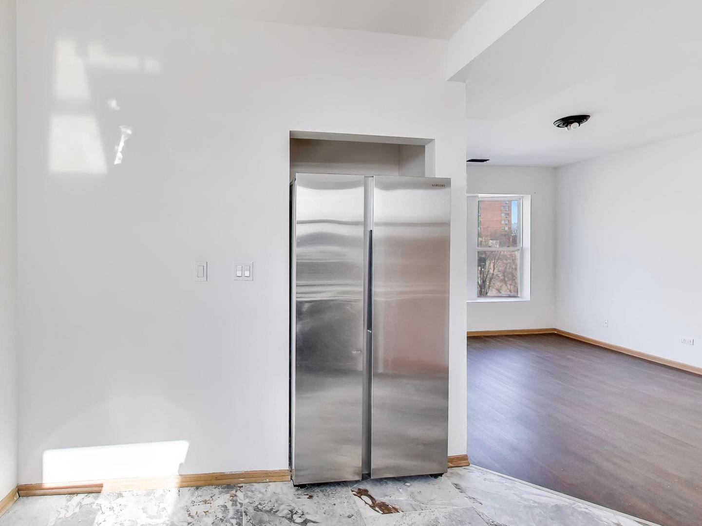 5000 South Champlain Avenue, Unit 3 Chicago, IL 60615 - Photo 8 of 17 a view of an empty room with wooden floor & a window