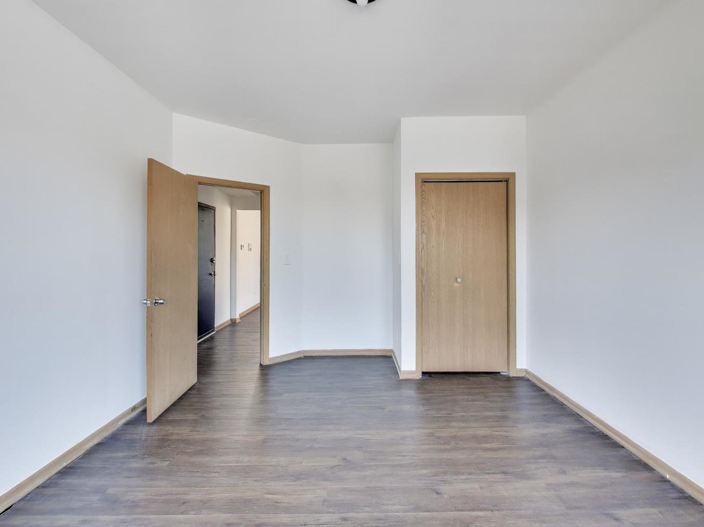 5000 South Champlain Avenue, Unit 3 Chicago, IL 60615 - Photo 10 of 17 a view of an empty room with wooden floor and closet