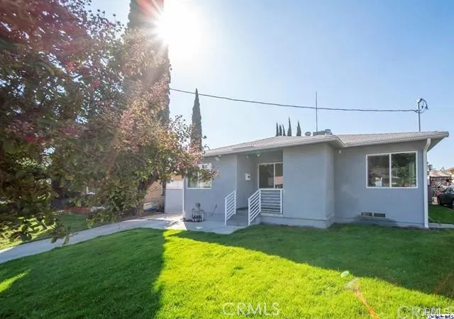a front view of house with yard and outdoor seating