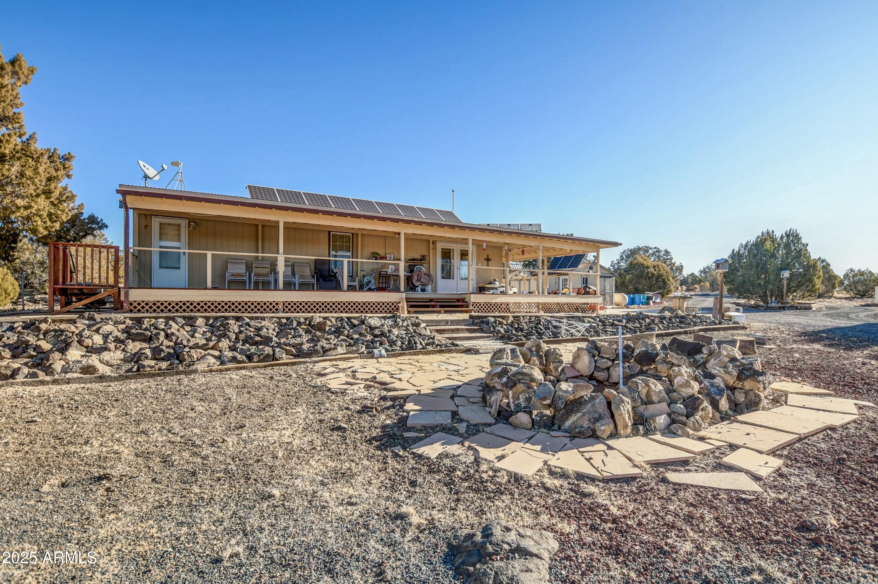 10777 West Raging Crab Road Seligman, AZ 86337 - Photo 3 of 45 Front of home with massive fire pit