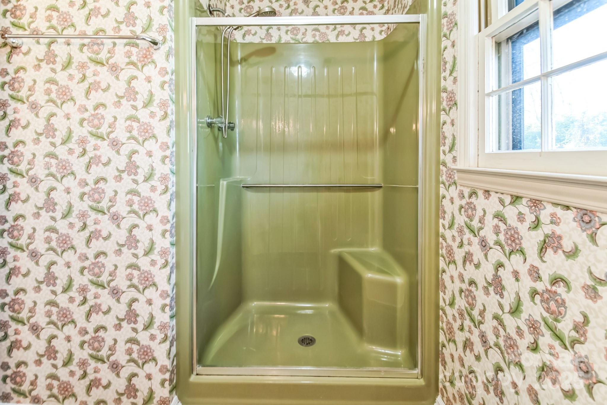 407 Covington Street Rockingham, NC 28379 - Photo 23 of 31 a bathroom with a glass shower door