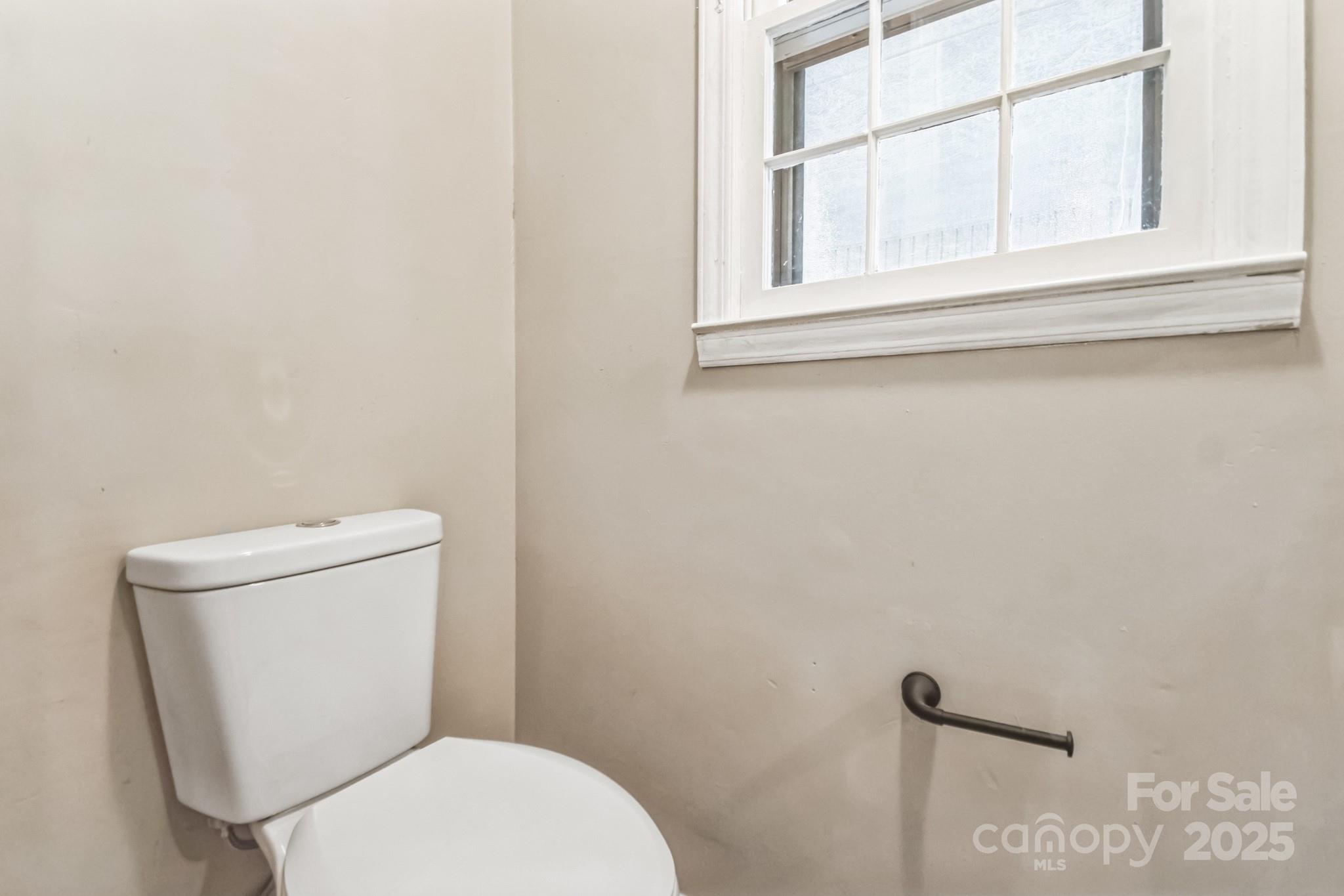 407 Covington Street Rockingham, NC 28379 - Photo 6 of 31 a white toilet sitting next to a window