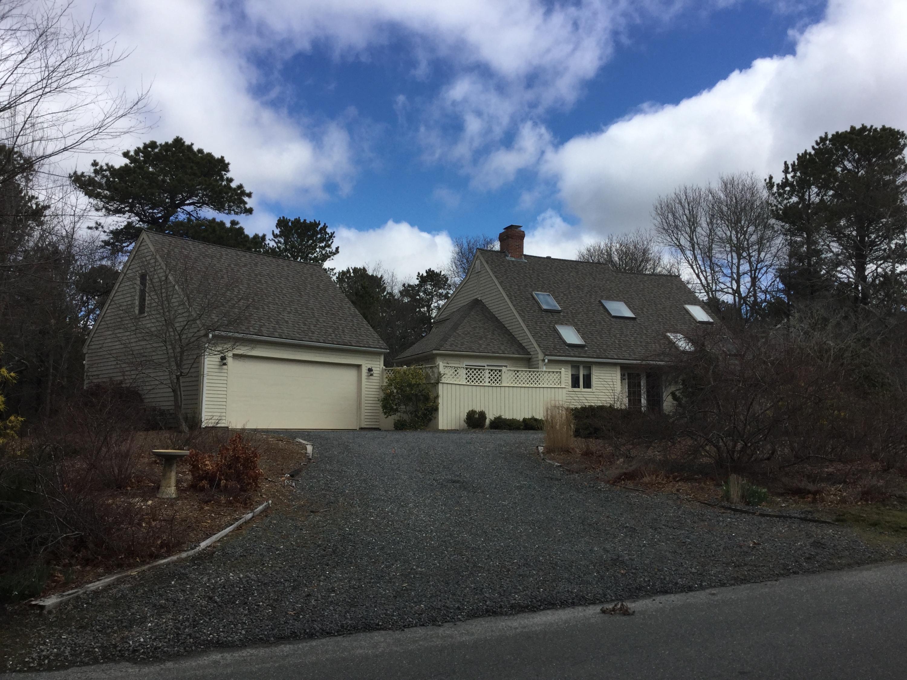 32 Amos Landing Road Mashpee, MA 02649 - Photo 29 of 29 a front view of a house with a yard and garage