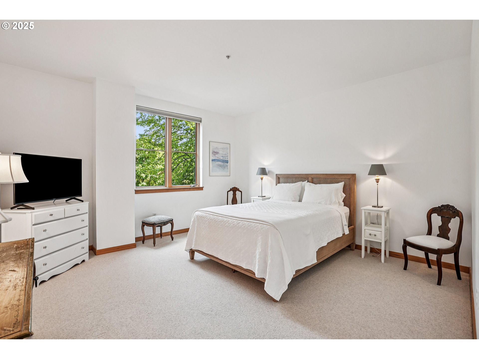 1030 Northwest Johnson Street, Unit 224 Portland, OR 97209 - Photo 17 of 36 a bedroom with a bed and furniture with a flat tv screen
