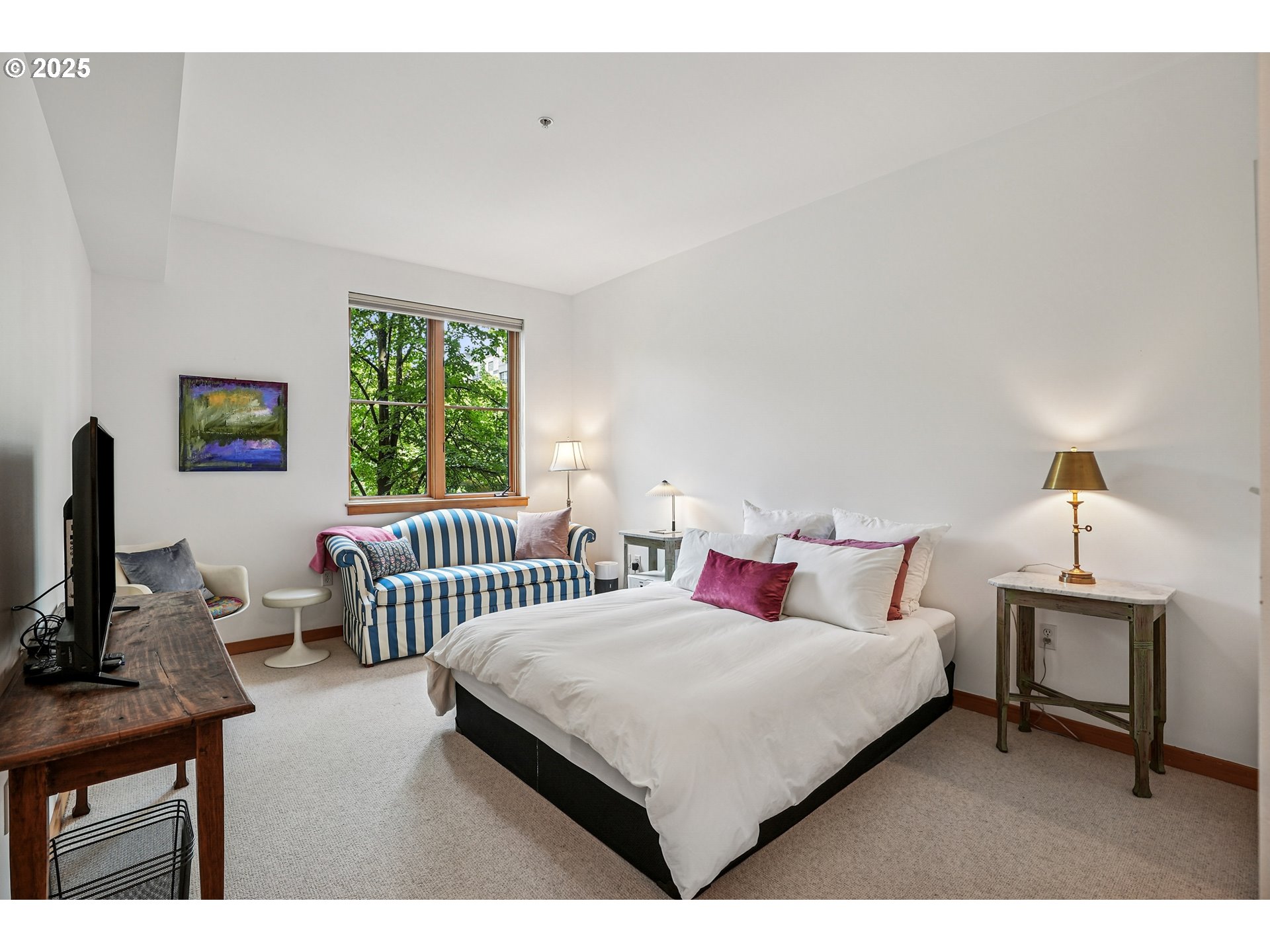 1030 Northwest Johnson Street, Unit 224 Portland, OR 97209 - Photo 20 of 36 a bedroom with a bed a large window and a flat screen tv