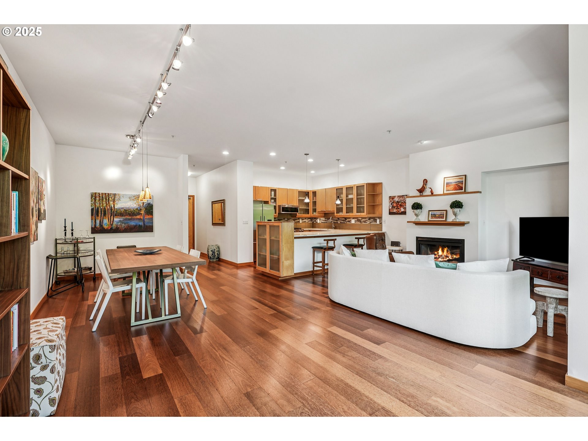 1030 Northwest Johnson Street, Unit 224 Portland, OR 97209 - Photo 2 of 36 a living room with furniture a wooden floor and a kitchen view