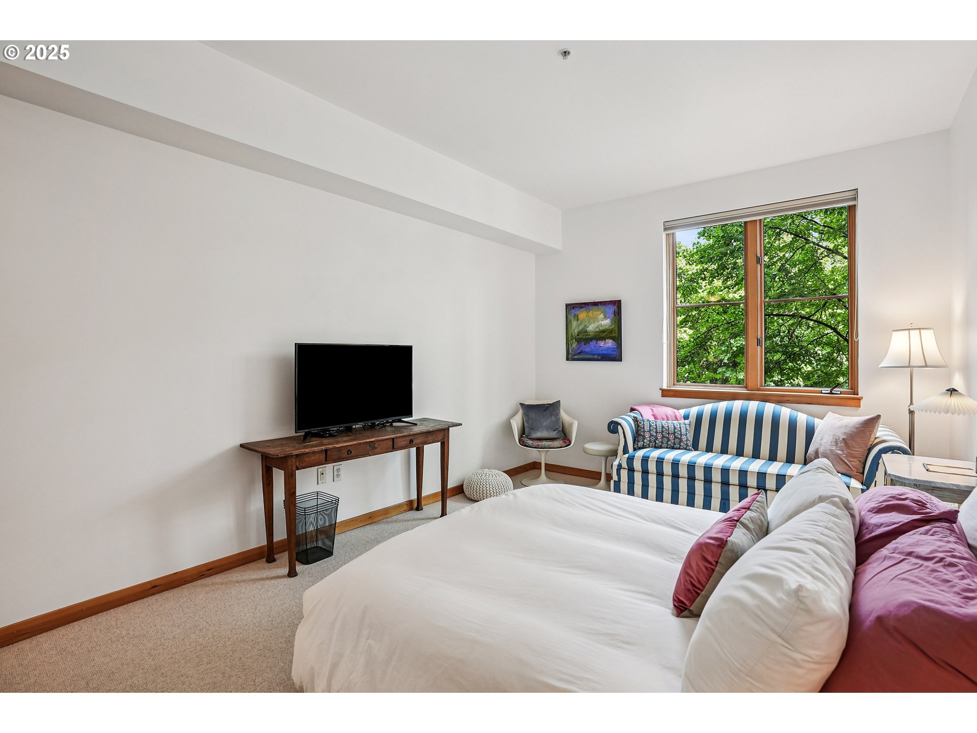 1030 Northwest Johnson Street, Unit 224 Portland, OR 97209 - Photo 21 of 36 a bedroom with a bed and a flat screen tv