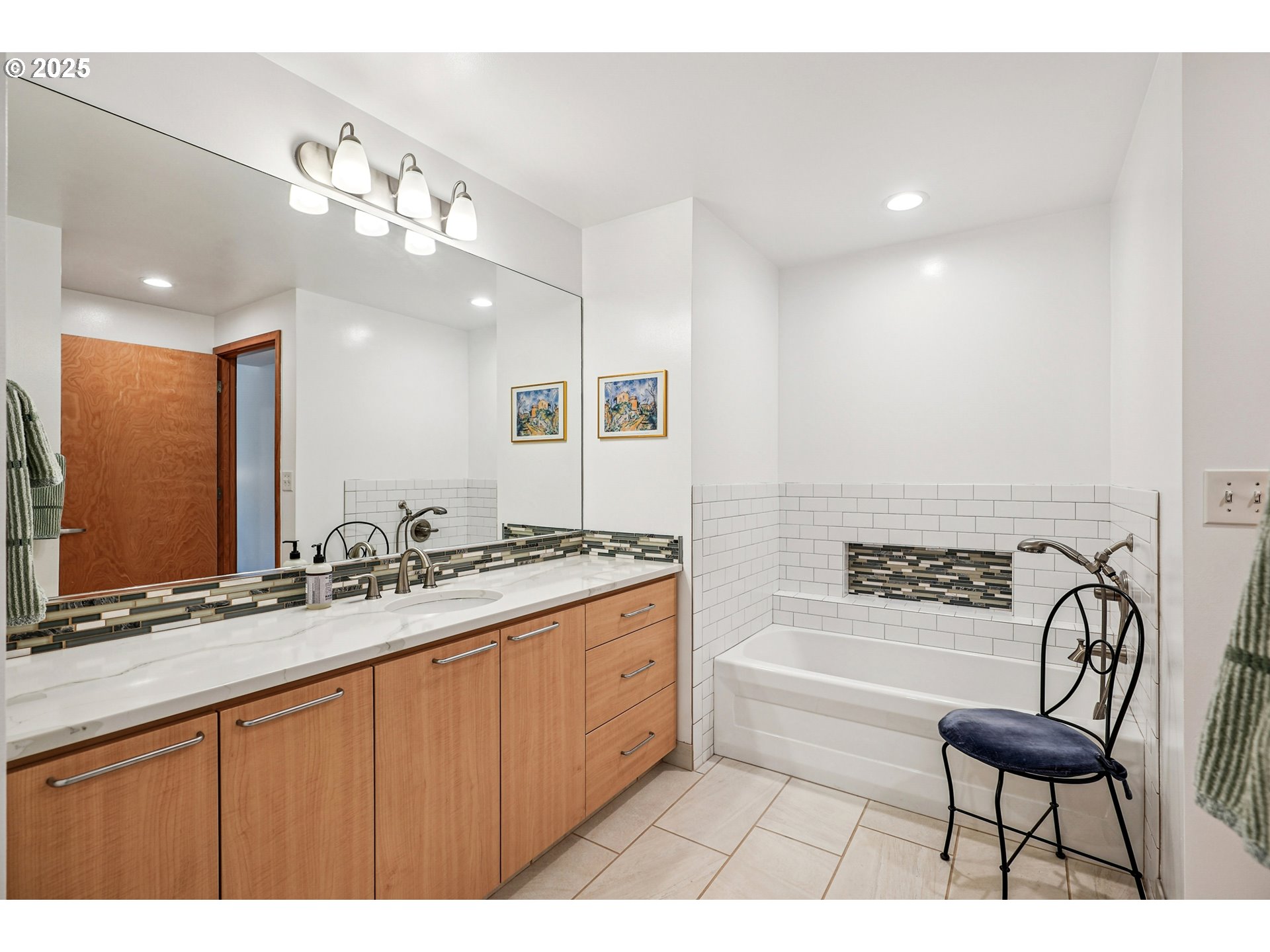 1030 Northwest Johnson Street, Unit 224 Portland, OR 97209 - Photo 26 of 36 a spacious bathroom with a granite countertop sink a toilet a mirror and bathtub