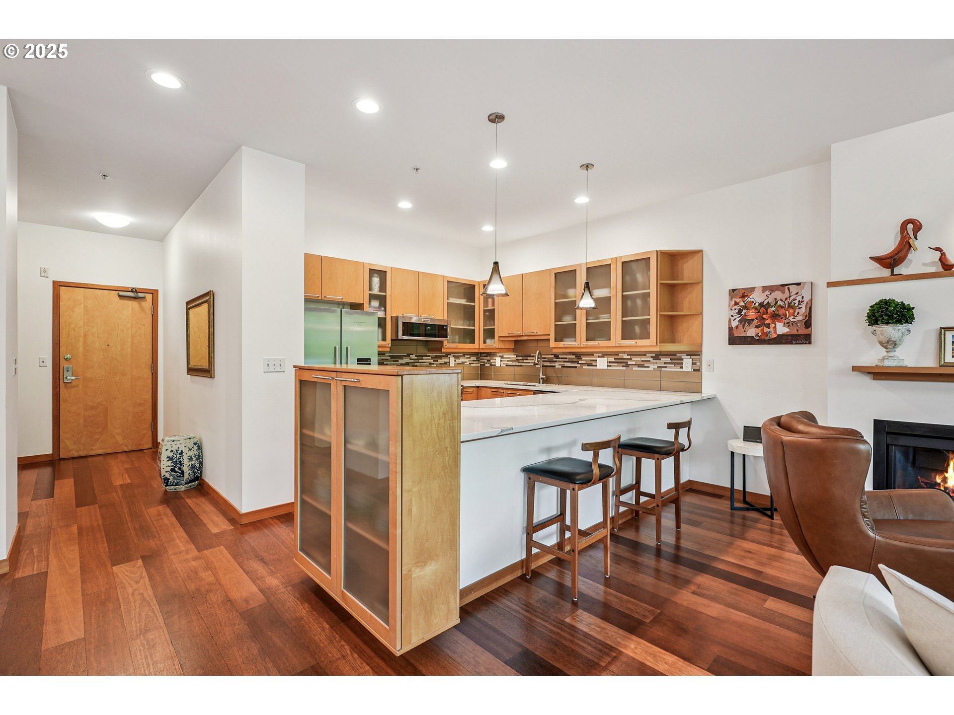 1030 Northwest Johnson Street, Unit 224 Portland, OR 97209 - Photo 3 of 36 a kitchen with stainless steel appliances granite countertop wooden floors and white cabinets