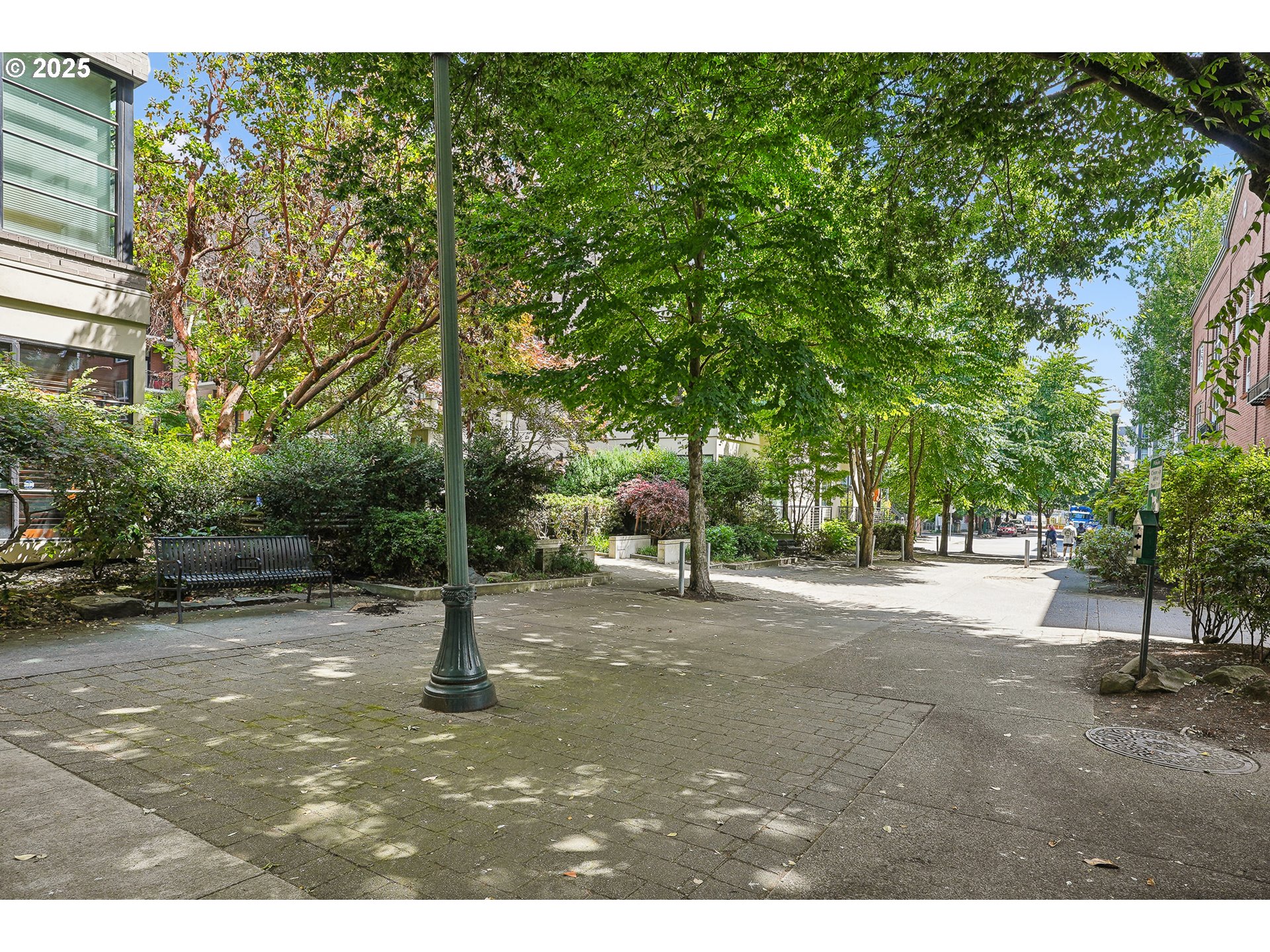 1030 Northwest Johnson Street, Unit 224 Portland, OR 97209 - Photo 31 of 36 a view of a street with trees and a building