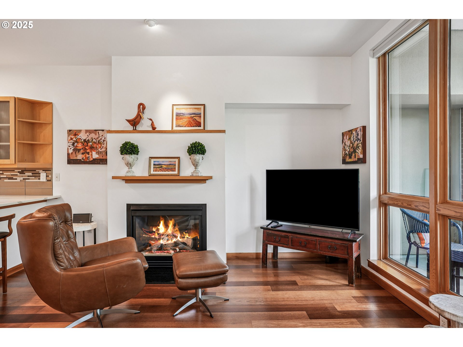 1030 Northwest Johnson Street, Unit 224 Portland, OR 97209 - Photo 4 of 36 a living room with furniture flat screen tv and a fireplace