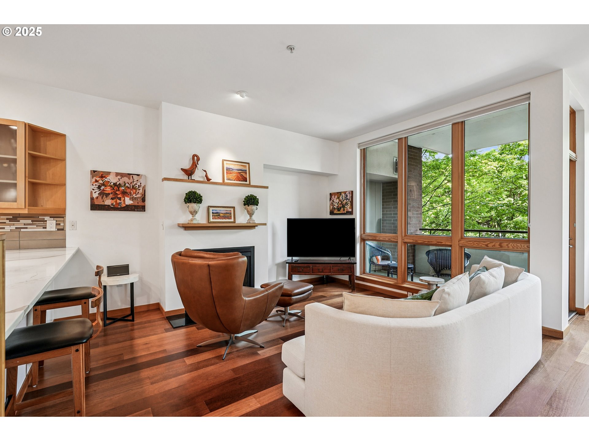 1030 Northwest Johnson Street, Unit 224 Portland, OR 97209 - Photo 6 of 36 a living room with furniture and a flat screen tv