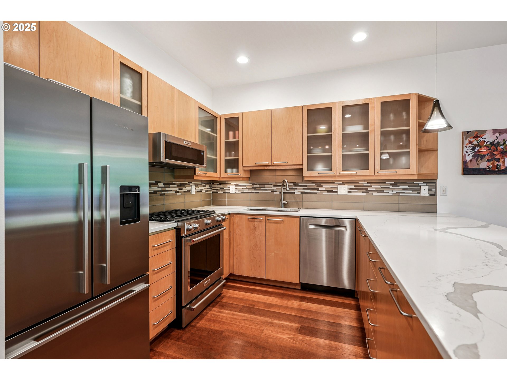 1030 Northwest Johnson Street, Unit 224 Portland, OR 97209 - Photo 7 of 36 a kitchen with stainless steel appliances granite countertop a refrigerator a stove and a sink