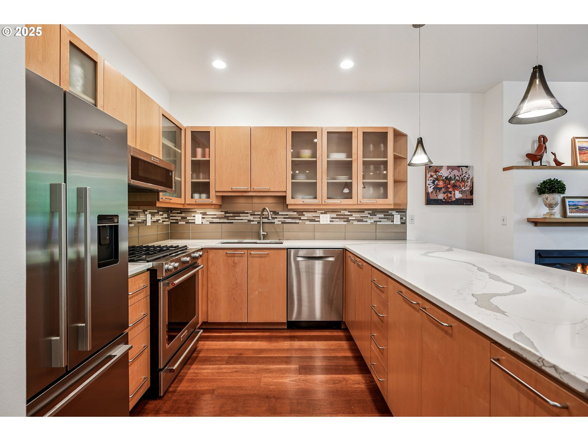 1030 Northwest Johnson Street, Unit 224 Portland, OR 97209 - Photo 8 of 36 a kitchen with stainless steel appliances granite countertop a sink stove and refrigerator
