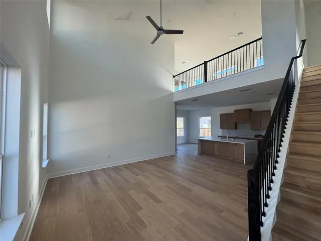 a view of a hallway with wooden floor and staircase