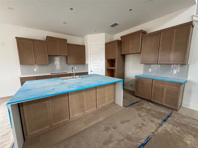 a kitchen with stainless steel appliances a sink stove and cabinets
