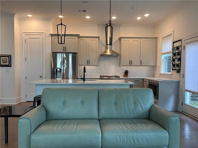 a living room with furniture and kitchen view