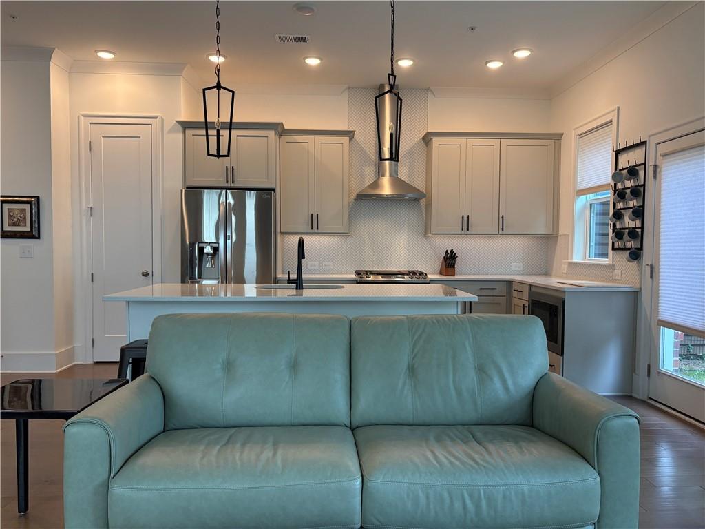 a living room with furniture and kitchen view