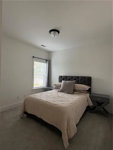 a bathroom with a sink a toilet a mirror and shower