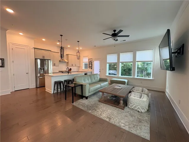a living room with furniture and a chandelier