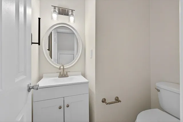 a bathroom with a toilet and a mirror