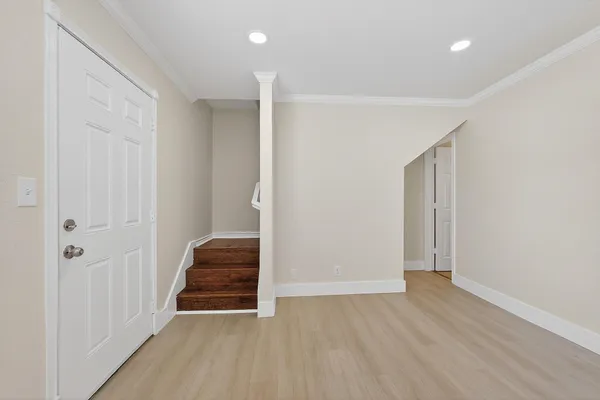 a view of room with a hallway and stairs