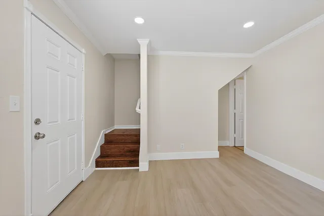 a view of room with a hallway and stairs