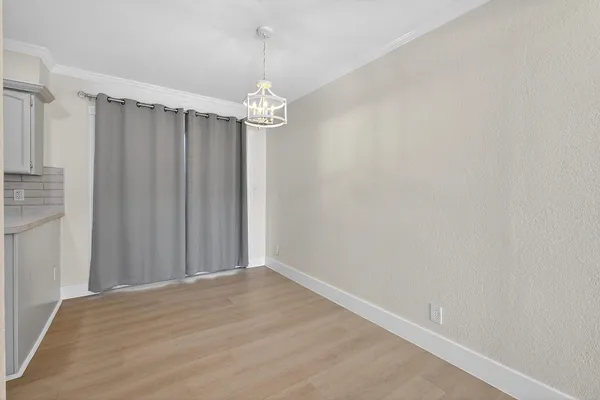 a view of a chandelier fan and hardwood floor