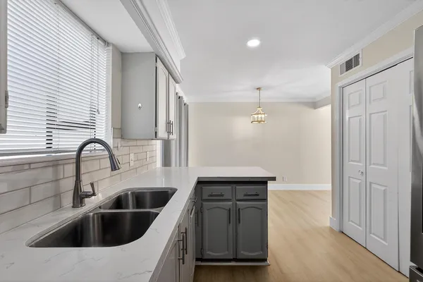a kitchen with a sink cabinets and stainless steel appliances