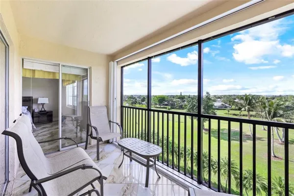 a view of a balcony with furniture