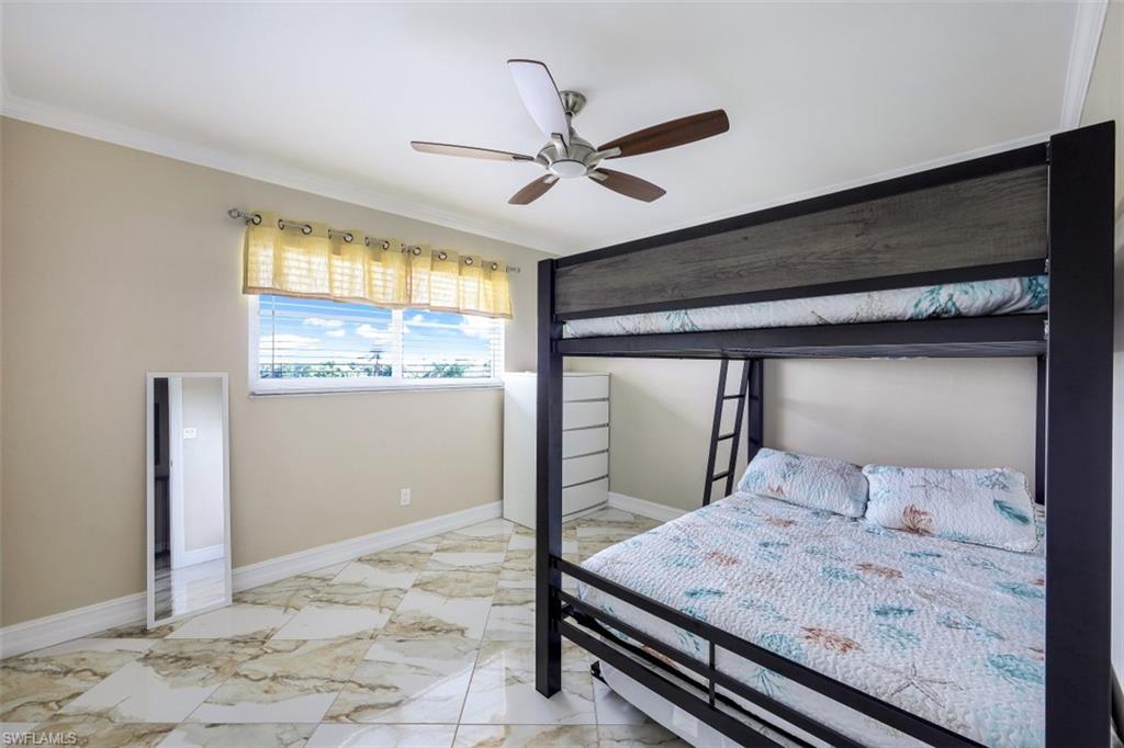 190 Pebble Beach Boulevard, Unit 502 Naples, FL 34113 - Photo 11 of 21 a bedroom with a bed and large window