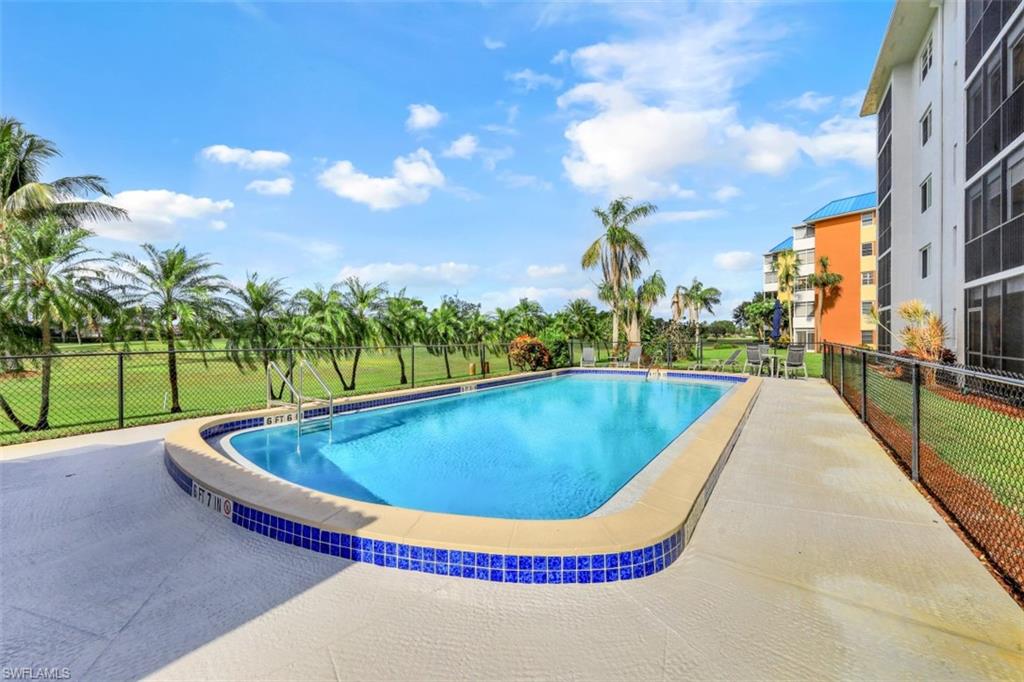 190 Pebble Beach Boulevard, Unit 502 Naples, FL 34113 - Photo 16 of 21 a view of swimming pool with a yard