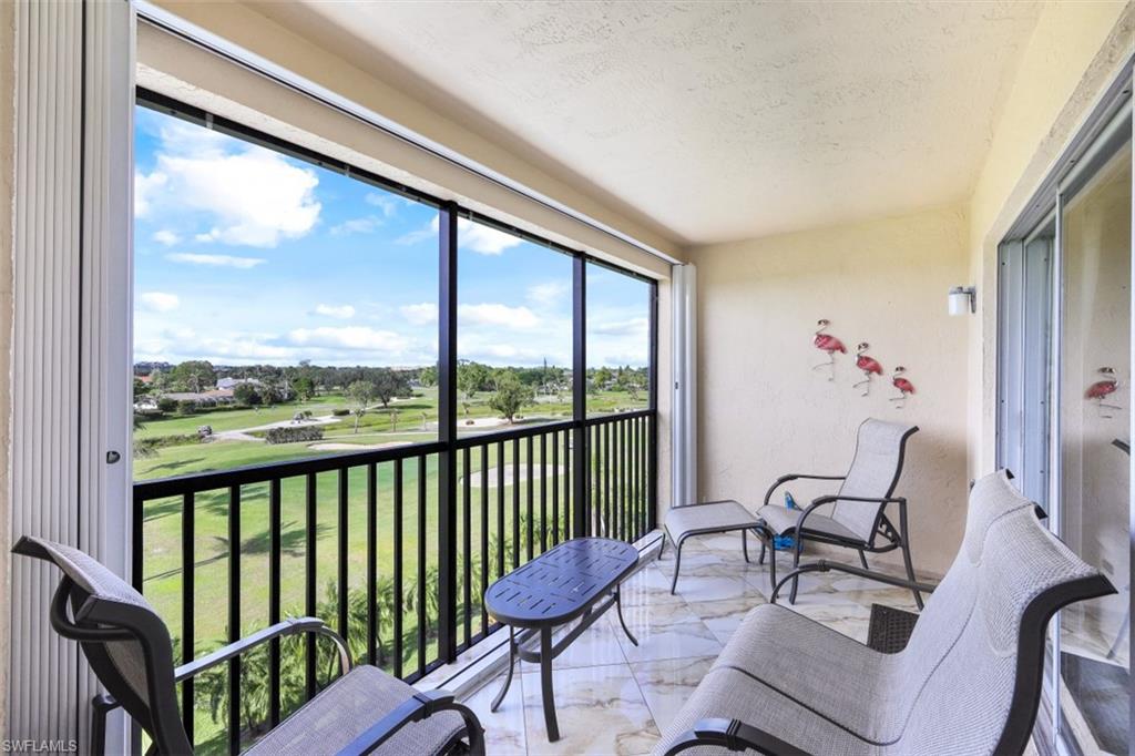 190 Pebble Beach Boulevard, Unit 502 Naples, FL 34113 - Photo 17 of 21 a view of a living room and a porch with furniture