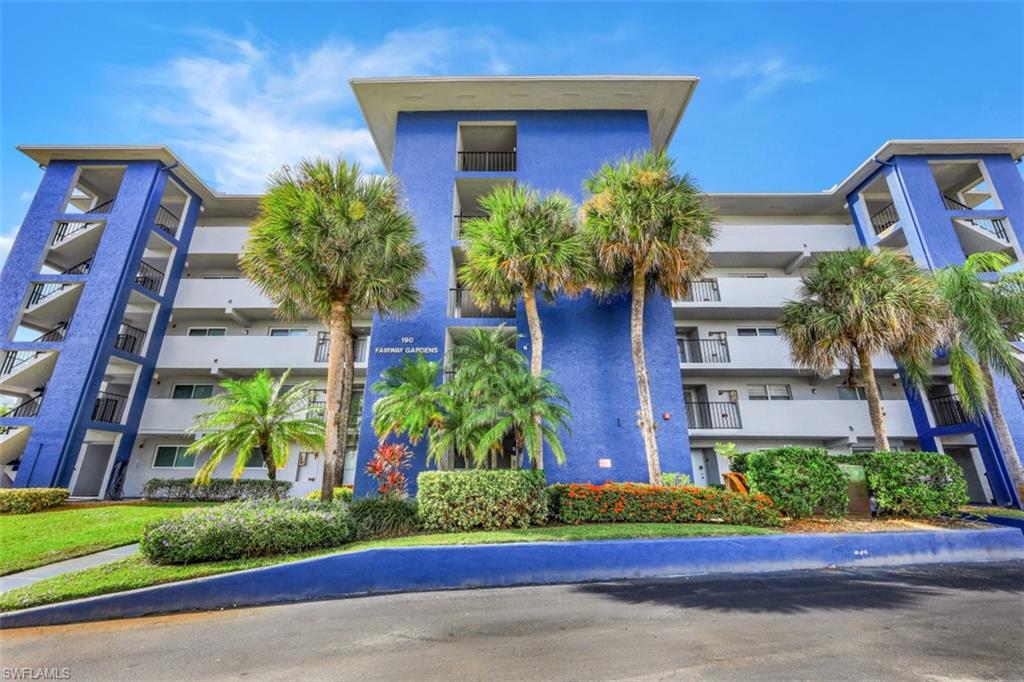 190 Pebble Beach Boulevard, Unit 502 Naples, FL 34113 - Photo 20 of 21 a front view of a house with a yard and potted plants