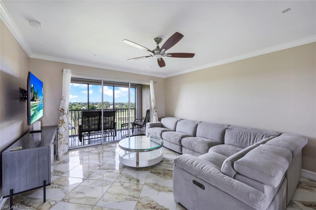 190 Pebble Beach Boulevard, Unit 502 Naples, FL 34113 - Photo 3 of 21 a living room with furniture and a flat screen tv