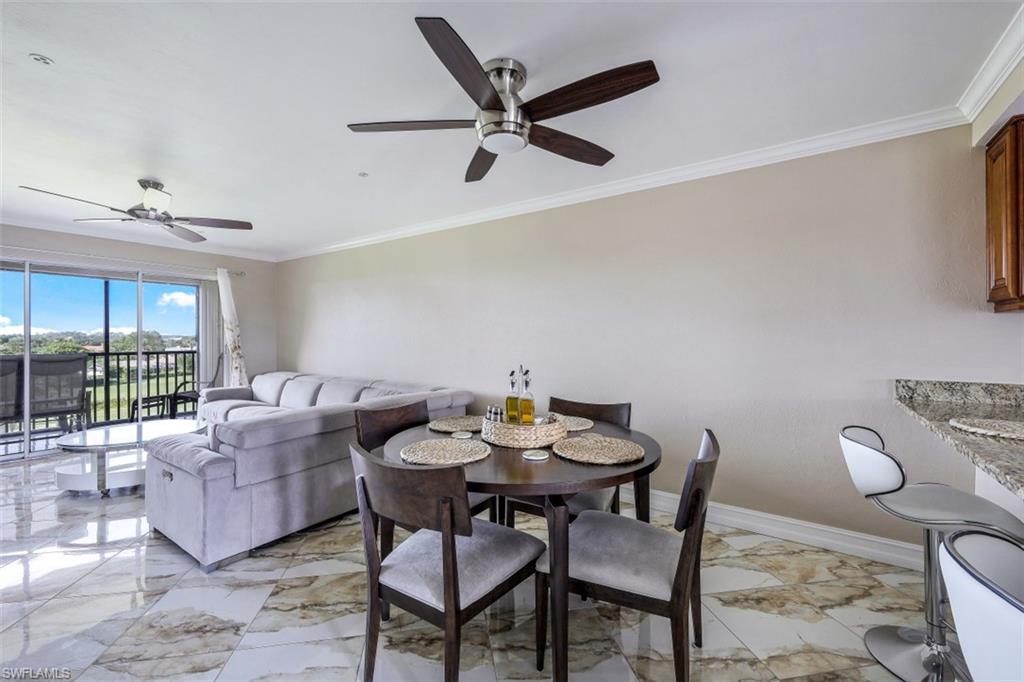 190 Pebble Beach Boulevard, Unit 502 Naples, FL 34113 - Photo 7 of 21 a living room with furniture and a large window