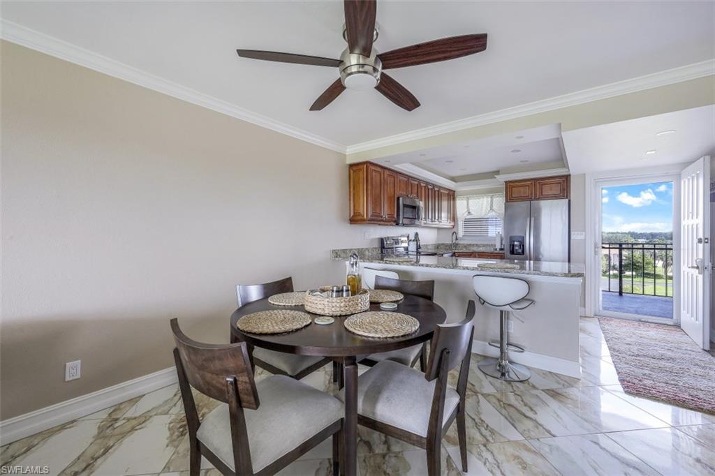 190 Pebble Beach Boulevard, Unit 502 Naples, FL 34113 - Photo 9 of 21 a view of a dining room with furniture and wooden floor