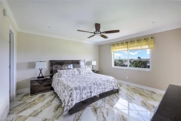 a bedroom with a large bed and a window